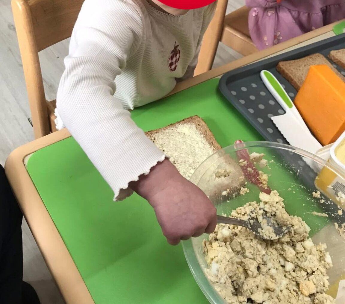 Hands mixing ingredients during a practical food activity