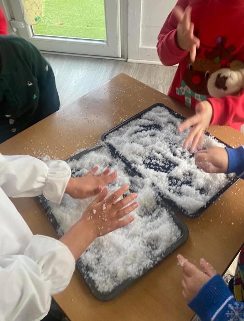 Children enjoying a Christmas snow sensory activity